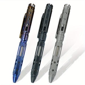 May include: Three tactical pens in a row, each with a unique colour. The first pen is a gradient of blue and bronze, the second is black, and the third is grey. All pens have a clip and a textured, slotted design.