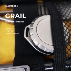 May include: A round, silver-colored titanium container labeled WANERSEN GRAIL. The container features a textured, ridged edge and a small loop attachment point. Text on the image includes Strong, Lightweight, and Corrosion Resistant.