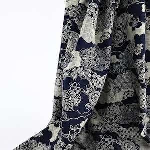 May include: Navy blue and off-white patterned fabric with a Japanese-inspired design. The fabric features floral and cloud motifs, creating a flowing, decorative pattern. The fabric is likely used for clothing or home decor.