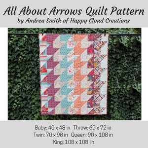 May include: A colorful quilt pattern called "All About Arrows" by Andrea Smith of Happy Cloud Creations. The quilt is made with a variety of fabrics in shades of pink, red, blue, and white. The quilt is hanging on a clothesline in front of a green ivy wall. The quilt is available in five sizes: Baby (40 x 48 inches), Throw (60 x 72 inches), Twin (70 x 98 inches), Queen (90 x 108 inches), and King (108 x 108 inches).