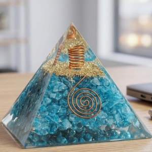 Amazonite crystal orgonite pyramid featuring turquoise blue stones and copper spiral coil, ideal for EMF shielding, chakra balancing, meditation practice, and Feng Shui energy enhancement.