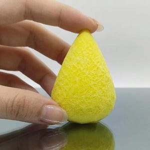 Raw yellow sapphire pear cut crystal with smooth polished finish, natural Pukhraj gemstone used for astrology Jupiter remedies, abundance attraction, and custom ring setting.