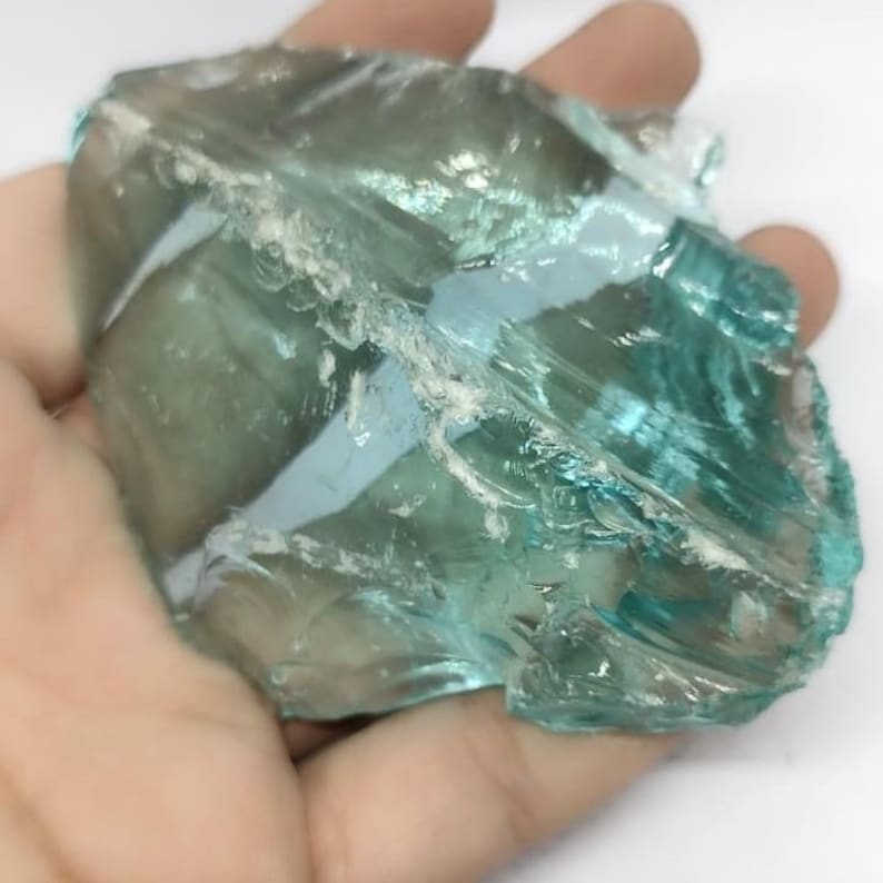 Raw blue green Andara obsidian stone with translucent shine and natural fractures, perfect for wire wrap pendants and spiritual gift ideas.