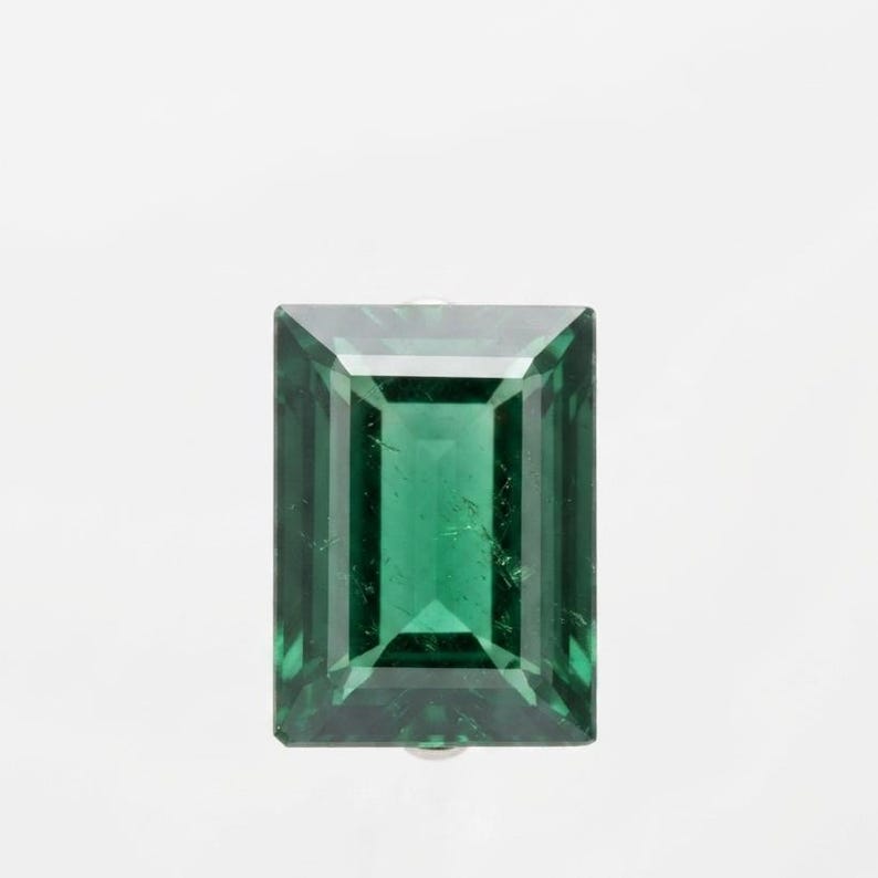 Rectangle cut green emerald loose gemstone featuring elegant step cut facets and vibrant green tone, perfect for custom engagement rings, anniversary jewelry gift and high end gemstone collector pieces.
