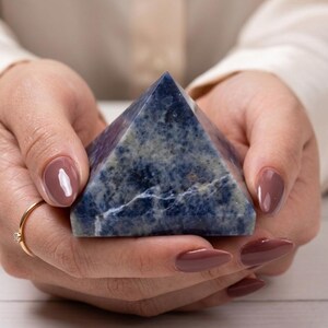 Decorative sodalite pyramid crystal with rich blue tones and white streaks, perfect for chakra alignment and positive energy.
