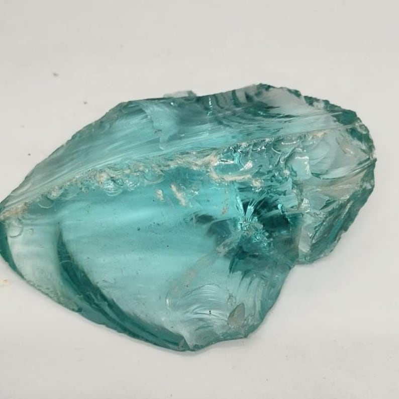 Blue green Andara obsidian raw stone with high clarity and organic shape, suitable for reiki healing sessions, meditation practice and jewelry design projects.