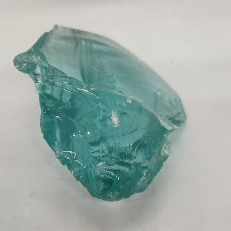 Natural Andara obsidian mineral specimen in aqua shade, raw volcanic glass crystal for protection energy and crystal collectors.