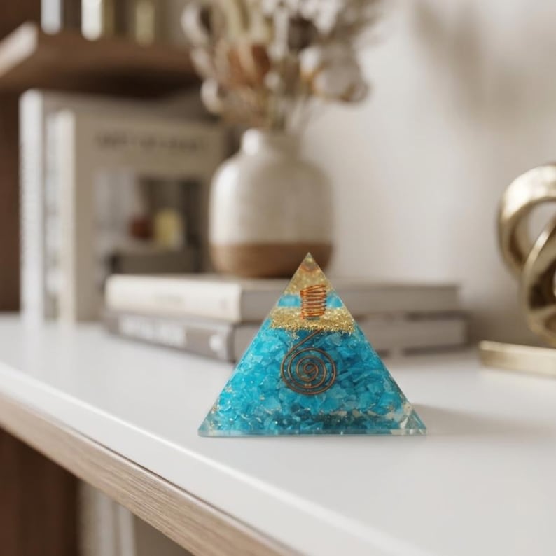 Handmade amazonite orgone pyramid with copper coil spiral inside resin, designed as an energy generator for EMF protection, throat chakra healing, Reiki meditation, and spiritual home decor.