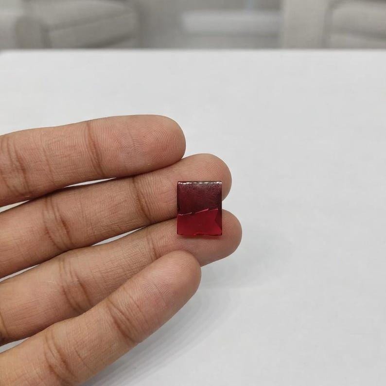 Precious July birthstone ruby cabochon with glossy dome surface and vivid red tone, perfect for luxury jewelry making