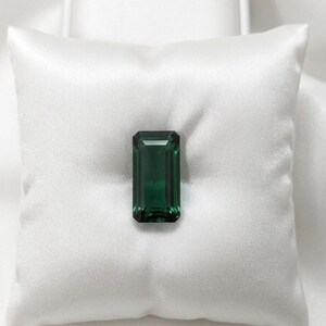 Premium emerald cut green emerald gemstone with rectangular step cut facets, loose precious stone perfect for custom engagement rings, pendants, necklaces and high-end jewelry making supplies.