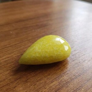 Yellow sapphire rough pear gemstone with luminous shine and natural inclusions, raw Pukhraj crystal suitable for astrology, prosperity rituals, and pendant setting.