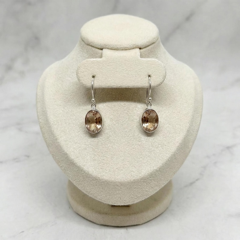 Soft peach gemstone earrings handcrafted in sterling silver, lightweight oval dangle design ideal for modern women who love minimalist jewelry and romantic wedding accessories.