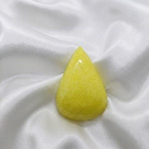 Natural pear shaped yellow sapphire rough stone with glossy texture and warm golden hue, Jupiter birthstone ideal for feng shui, vastu correction, and spiritual gifting.