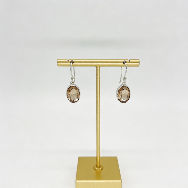 Elegant peach gemstone dangle earrings in sterling silver, oval cut crystal jewelry designed for bridesmaid proposals, wedding day styling or chic office wear accessories.