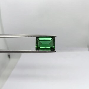 Loose natural emerald gemstone in rectangle shape showcasing deep green brilliance and polished finish, ideal for custom ring setting, pendant making and luxury jewelry supply.