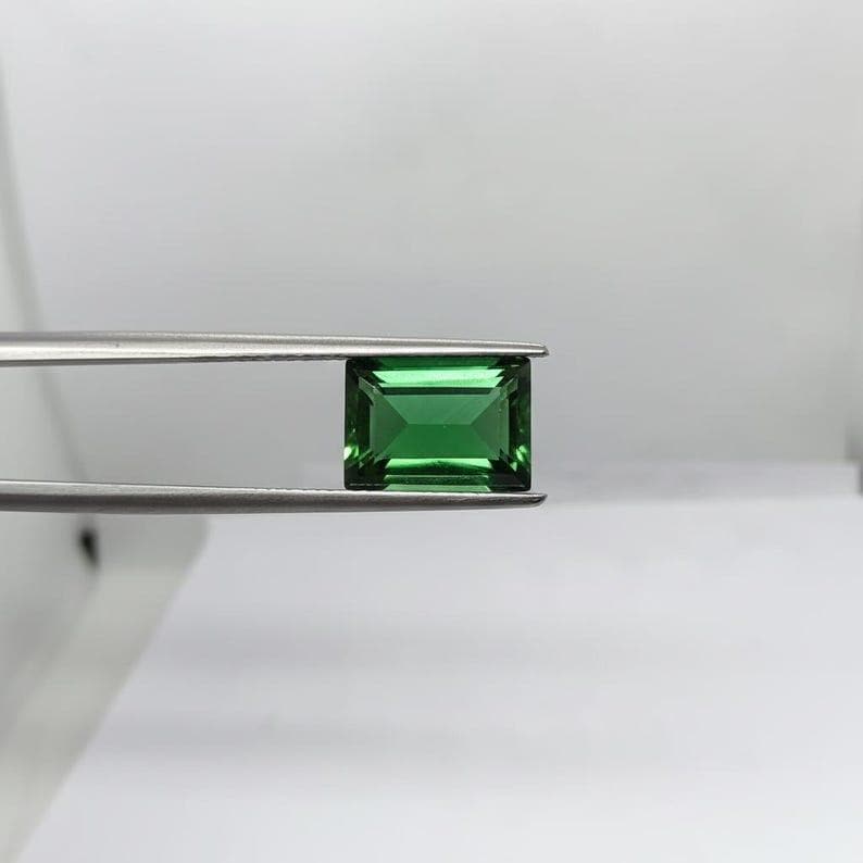 Loose natural emerald gemstone in rectangle shape showcasing deep green brilliance and polished finish, ideal for custom ring setting, pendant making and luxury jewelry supply.