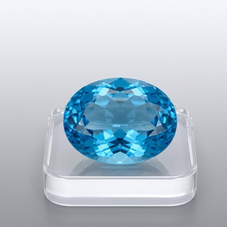 Luxury natural Swiss Blue Topaz oval cut stone with vivid bright blue color, loose precious gem for handcrafted jewelry and gemstone collections.