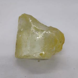 Natural lemon quartz uncut stone for jewelry making and spiritual use, featuring soft lemon yellow shade and natural crystal formation.