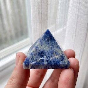 Blue sodalite gemstone pyramid with smooth polished finish, spiritual protection stone for meditation room and altar decor.