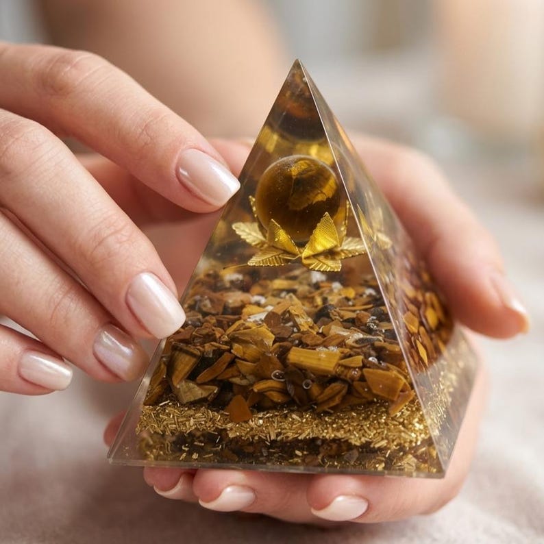 Tiger eye gemstone energy pyramid used in crystal grids for abundance, courage, and leadership strength.