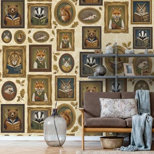 May include: A whimsical wallpaper design featuring framed portraits of anthropomorphic animals reading books. The animals include a bear, fox, badger, squirrel, hedgehog, lion, cat, and owl. The portraits are set against a cream-colored background with oak leaf accents.