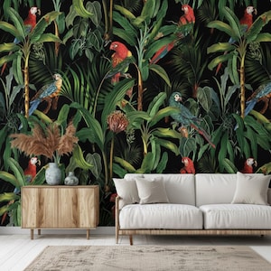 May include: A vibrant wallpaper featuring a lush tropical jungle scene with parrots. The design showcases a black background with dense green foliage, palm trees, and colorful parrots in shades of red, blue, and green. A wooden cabinet, sofa, and rug are in the foreground.