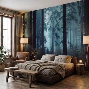 May include: A bedroom with a forest mural, a wooden bed frame, and a bench. The bed is covered with a gray blanket and pillows. A leather armchair and a floor lamp are on the left. A small table with a lantern is on the right.