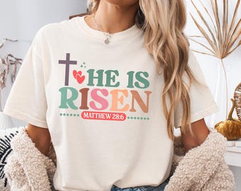 Camiseta cristiana de Pascua "Él ha resucitado", camiseta con versículo bíblico de Mateo 28:6, camiseta religiosa con cruz de fe, camiseta para la iglesia del Domingo de Pascua.