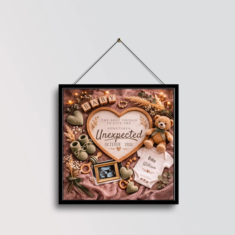 May include: A framed square print with a baby-themed arrangement. It includes a heart-shaped wooden sign with the word "Unexpected" and the date "October 2026", a teddy bear, baby shoes, a onesie, and a sonogram photo.