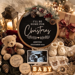 May include: A Christmas-themed baby announcement. A black letter board with the text "I'll be home for Christmas" and "Arriving December 2026". Includes a teddy bear, baby booties, ultrasound image, and wooden blocks spelling "BABY".