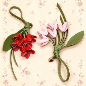 May include: Two decorative leather flower charms featuring green stems and leaves. One charm displays a cluster of vibrant red petals, while the other showcases a bouquet of soft pink petals. Each piece includes a loop for attachment and a small gold-tone metal charm.