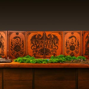 May include: A five-panel wooden Dungeon Master screen featuring intricate black laser-engraved illustrations of dragons, dice, and gothic architecture. The central panel displays the text Dungeon Master in a bold, stylized font.