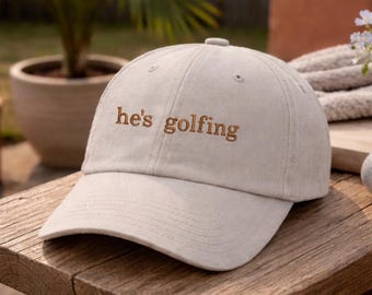 Embroidered He’s Golfing Hat, Golf Season Baseball Cap, Vintage Golf Dad Hat, Minimalist Golf Lover Gift, Unisex Sport Dad Cap, Golfing Gift