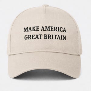 May include: A beige baseball cap with the text "MAKE AMERICA GREAT BRITAIN" printed in black. The cap has a curved brim and a button on top.