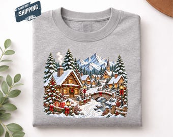 クリスマスビレッジシャツ、雪景色の冬のコテージTシャツ、居心地の良いクリスマストップス、彼女へのクリスマスギフト、ヴィンテージホリデースノービレッジシャツ