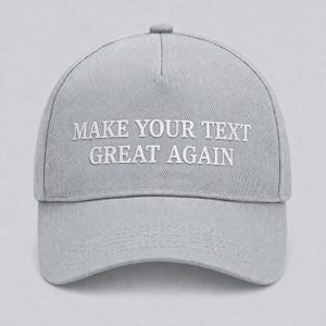 May include: A light gray baseball cap with the embroidered text "MAKE YOUR TEXT GREAT AGAIN" in white. The cap has a curved brim and a button on top. The hat is made of a durable fabric.