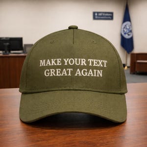 May include: Olive green baseball cap with the embroidered text "MAKE YOUR TEXT GREAT AGAIN" in white. The cap has a curved brim and a button on top. The hat is made of a durable fabric.