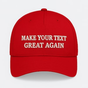 May include: A red baseball cap featuring the white embroidered phrase "MAKE YOUR TEXT GREAT AGAIN". The cap has a curved peak and a rounded crown, a common style for baseball caps.