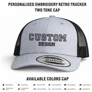 May include: A grey and black retro trucker cap with the embroidered text "CUSTOM DESIGN". The cap features a mesh back and a snapback closure. The text "PERSONALISED EMBROIDERY RETRO TRUCKER TWO TONE CAP" is at the top. Available in various colours.