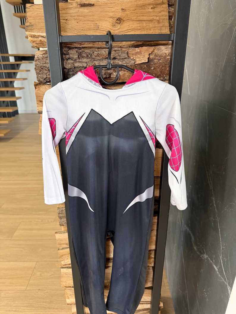 May include: A white ceramic mug with a black handle and the text "But First, Coffee" in a black, handwritten-style font. The mug is on a white surface.