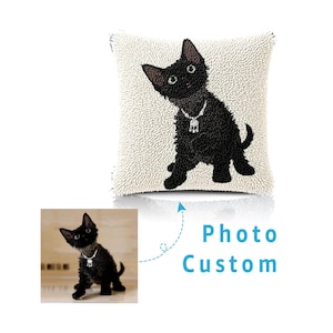 May include: A square throw cushion featuring a textured punch needle design of a black cat wearing a silver necklace. Below the cushion, a smaller reference photograph shows the same cat, with the blue text Photo Custom and an arrow pointing up.
