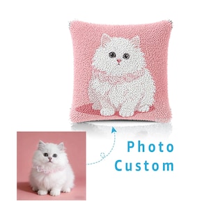 May include: A square throw pillow with a textured, looped pile surface in pink, featuring a white cat illustration. Below, a smaller square photograph shows a white cat with a pink collar, accompanied by the blue text Photo Custom.