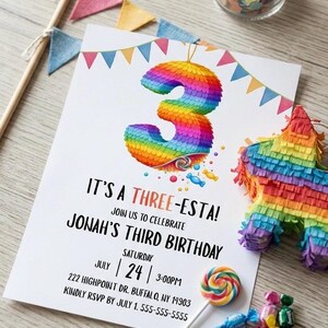 May include: A birthday party invitation with a colorful rainbow number 3 piñata design. The invitation reads "It's a Three-esta!" and includes party details. A small piñata, candy, and a lollipop are also visible.