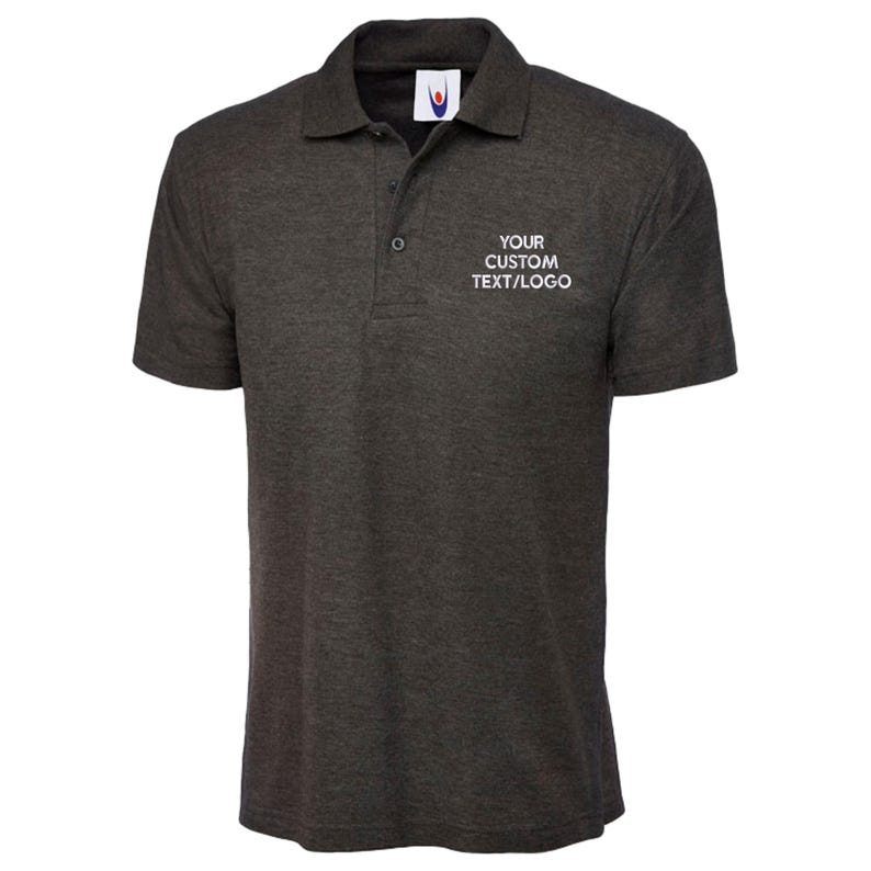 May include: Dark grey polo shirt with a collar and short sleeves. The shirt features a three-button placket and the text "YOUR CUSTOM TEXT/LOGO" on the chest. Made from a soft, textured fabric.