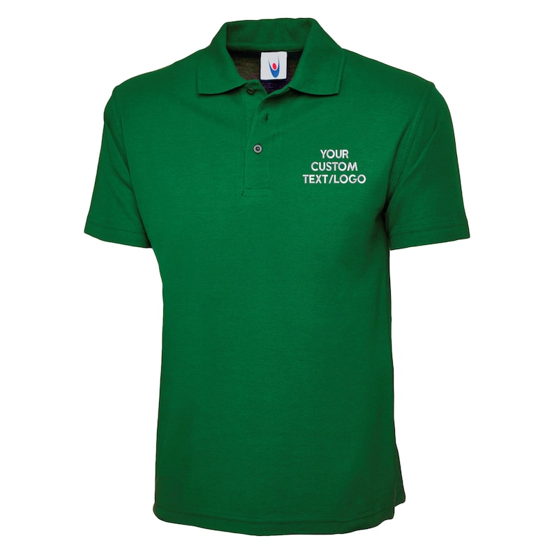 May include: A green polo shirt with short sleeves and a collar. The shirt has a three-button placket and the text "YOUR CUSTOM TEXT/LOGO" printed in white on the chest. The shirt is made of a soft, breathable fabric.