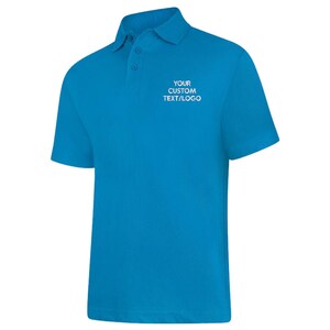 May include: A vibrant blue polo shirt with short sleeves and a collar. The shirt features three buttons at the neckline and the text "YOUR CUSTOM TEXT/LOGO" in white on the chest.