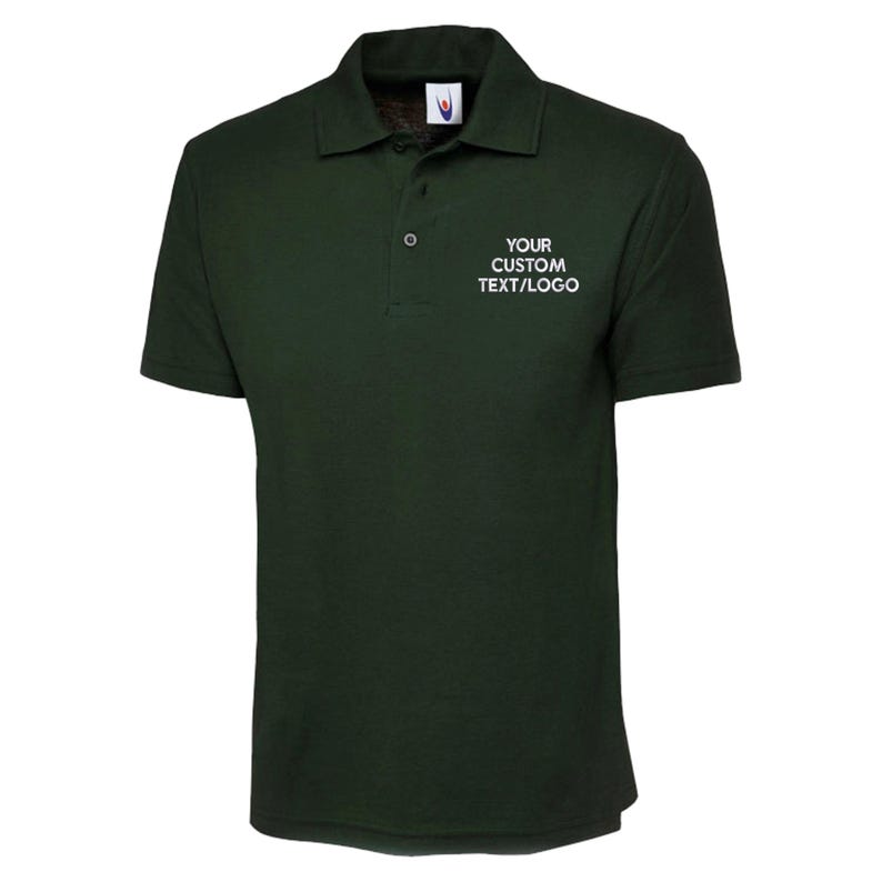 May include: Dark green polo shirt with short sleeves and a collar. The shirt features a three-button placket and the text "YOUR CUSTOM TEXT/LOGO" in white on the chest. Made from a soft, breathable fabric, suitable for various activities.