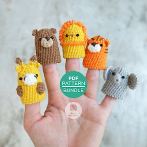 Op de afbeelding: Een set van vijf vingerpoppen met een leeuw, tijger, giraffe, beer en olifant. De poppen zijn gehaakt in verschillende kleuren, waaronder geel, oranje, bruin en grijs. De poppen zijn op een hand geplaatst, met de tekst "PDF PATTERN BUNDLE" zichtbaar op de achtergrond.