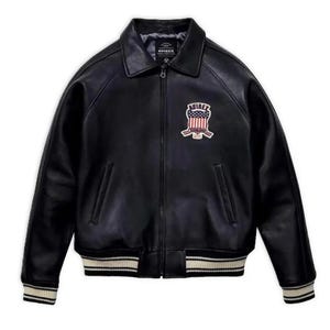 May include: Black leather jacket with a collared neckline, zipper closure, and a patch on the chest. The jacket features a ribbed hem and cuffs with white stripes. The patch displays a shield design with the word "AVIREX".