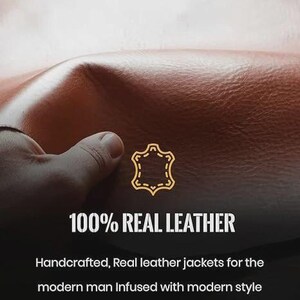 May include: Close-up of brown leather with the text "100% REAL LEATHER". The image shows a hand touching the leather. The text below reads "Handcrafted, Real leather jackets for the modern man Infused with modern style and a touch of luxury."